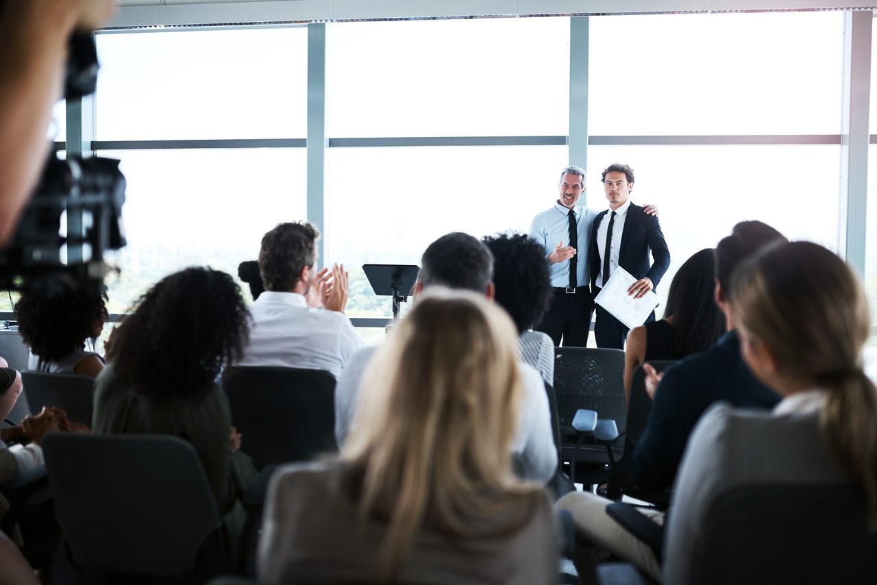 An audience applauding during a professional presentation